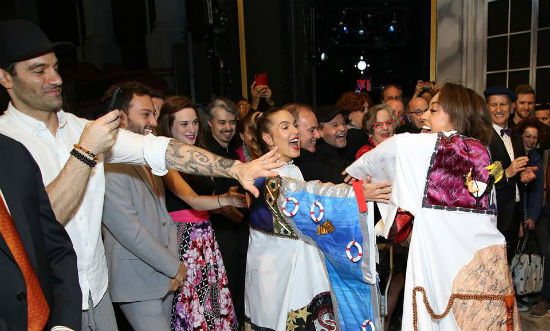 Co-stars and supporters reach out to touch the Robe for good luck!