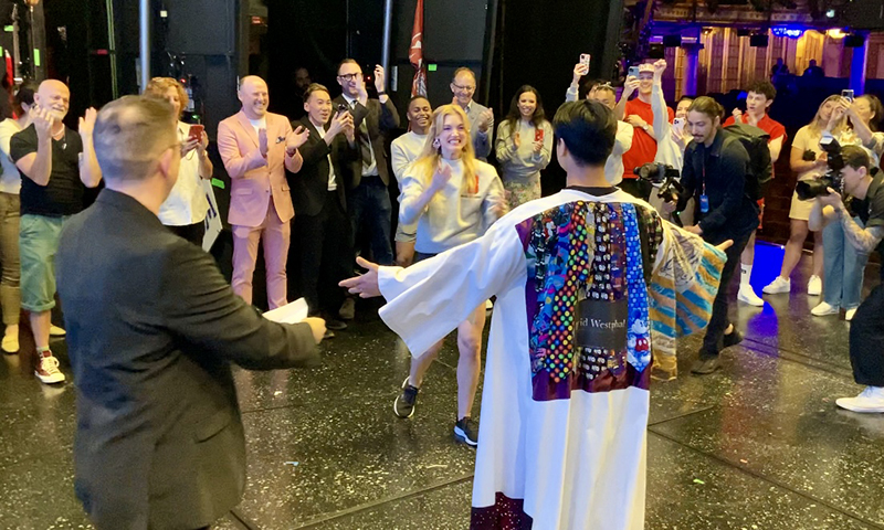 Jonalyn Saxer receives the Robe from previous recipient Angelo Soriano. Photo by Jeffrey Bateman.